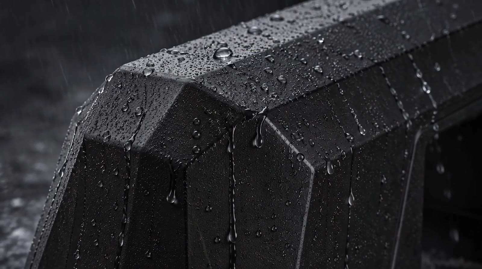 Trampoline Weight outdoors in the rain — actual product, water beading on the molded shell